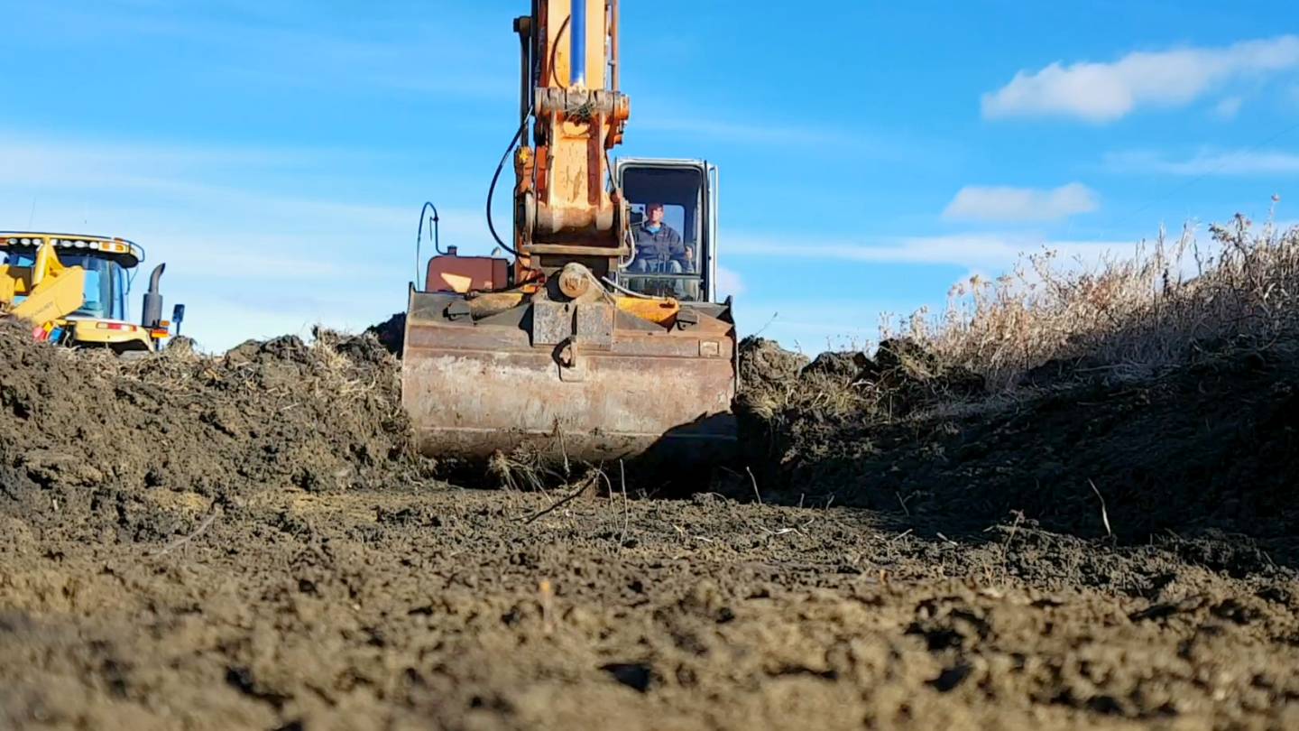 Excavator performing bulk earthworks on a construction site